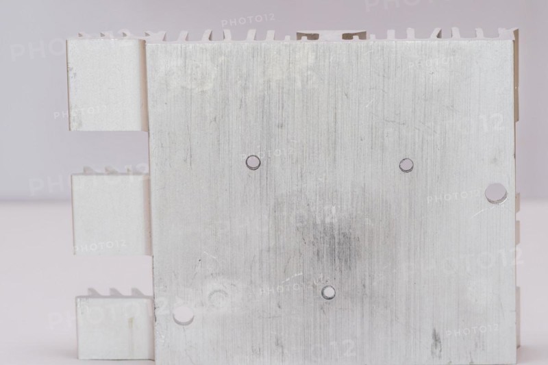 Closeup of mounting surface of rectangle aluminum heat sink on white background