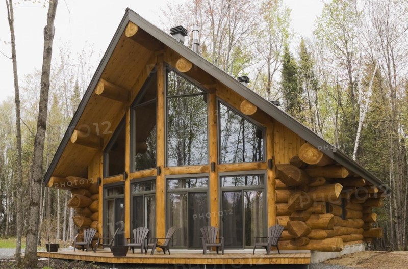 Luxurious Scandinavian style log home with large panoramic windows in spring, Quebec, Canada, North America