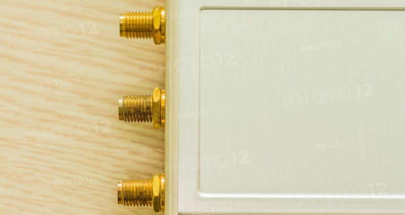Close-up of gold connectors for antenna ports on beige casing, in South Korea