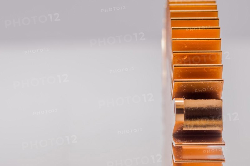 Closeup of copper computer heat sink fins on white background