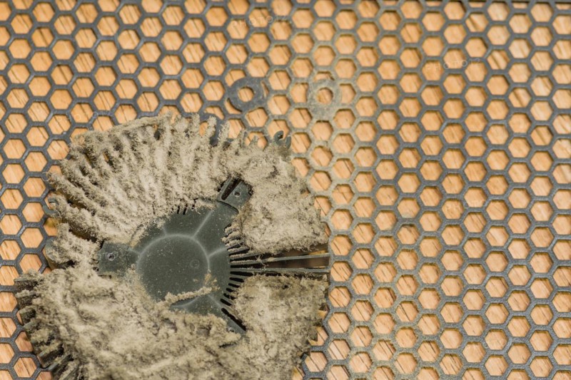 Central processing unit (CPU) with remnants of dried thermal paste on a patterned background, in South Korea