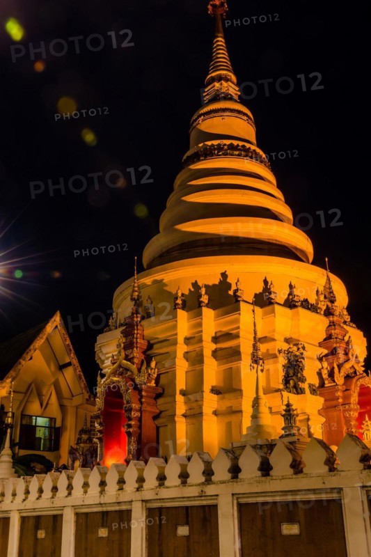 Illuminated temple with golden lights stands out against the dark night, in Chiang Mai, Thailand, Asia