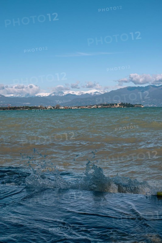 View over the wavy Lake Garda under a blue sky with clouds, Sirmione, Lake Garda, Italy, Europe
