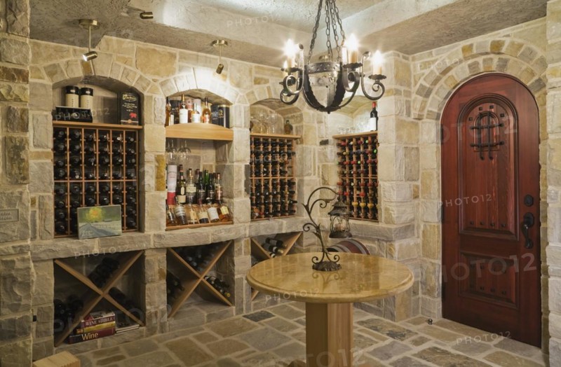 Medieval style beige and tan cut stone wine cellar in basement inside elegant style home, Quebec, Canada, North America