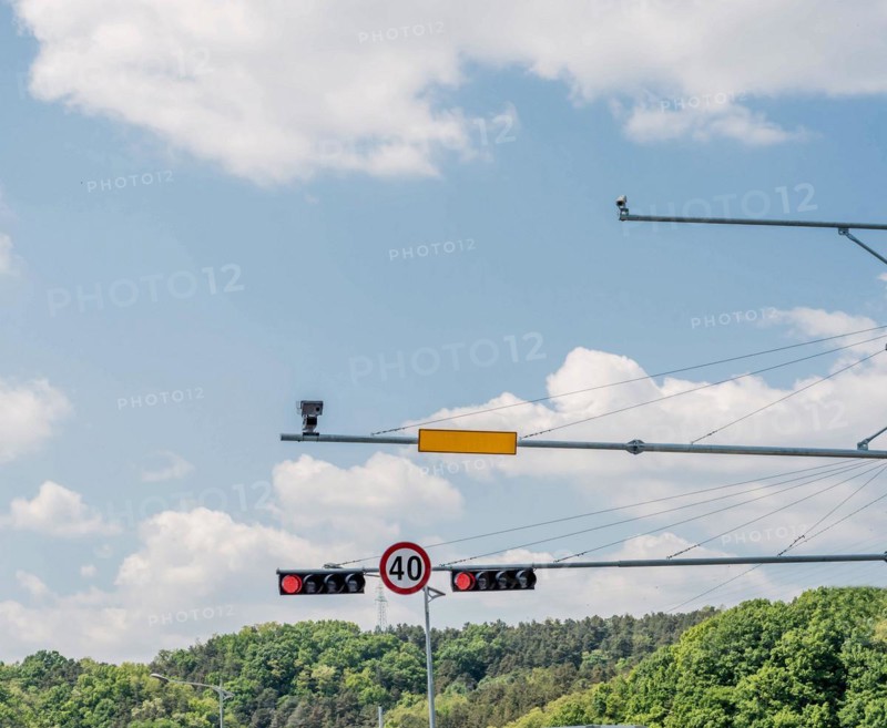 Traffic lights and a blank road sign against a clear sky with a 40 km/h speed limit, in South Korea