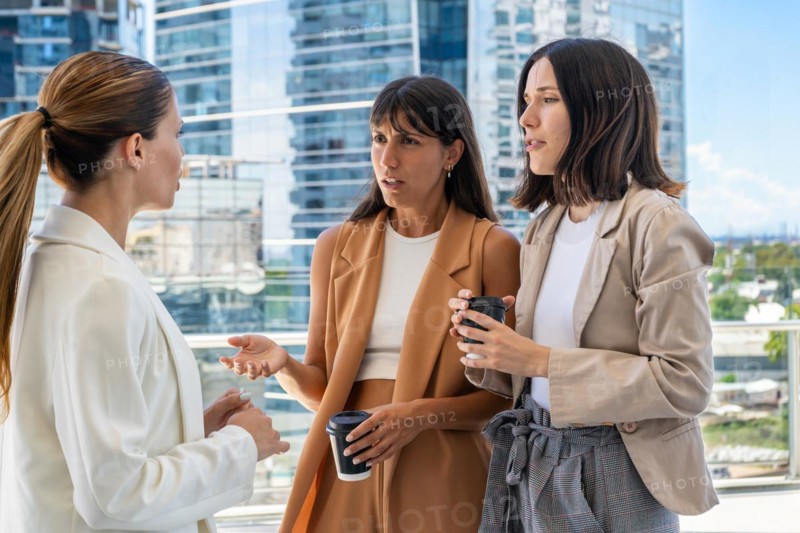 The female boss is informing her two employees that they need to focus on work rather than engaging in gossip. One of them does not like her comment