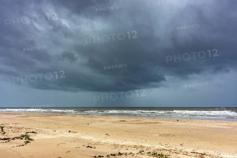 Dark rain clouds over the sea at Sargi beach in Serra Grande on the coast of Bahia, Bahia, Brazil, South America