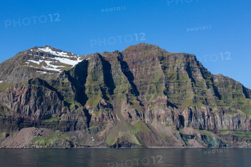 Rugged mountains and steep sea cliffs along the fjord Seyoisfjoerour, Seydisfjoerdur in summer, Eastern Region, Austurland, Iceland, Europe