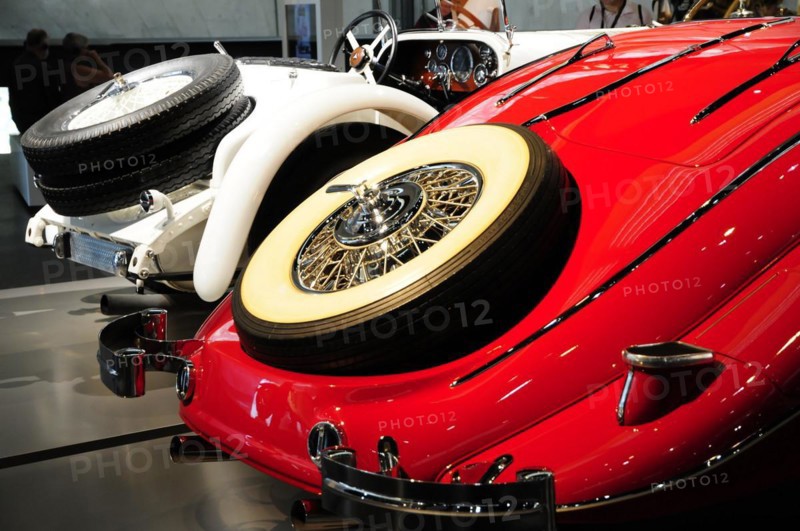 Museum, Mercedes-Benz Museum, Stuttgart, Side view of a red and white classic car with distinctive spoked wheels, Mercedes-Benz Museum, Stuttgart, Baden-Wuerttemberg, Germany, Europe