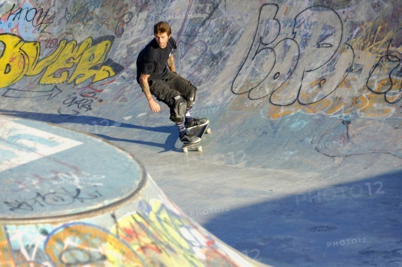 A skateboarder prepares to perform a trick in a half-pipe against the light of the evening sun, Marseille, Bouches-du-Rhone department, Provence-Alpes-Cote d'Azur region, France, Europe