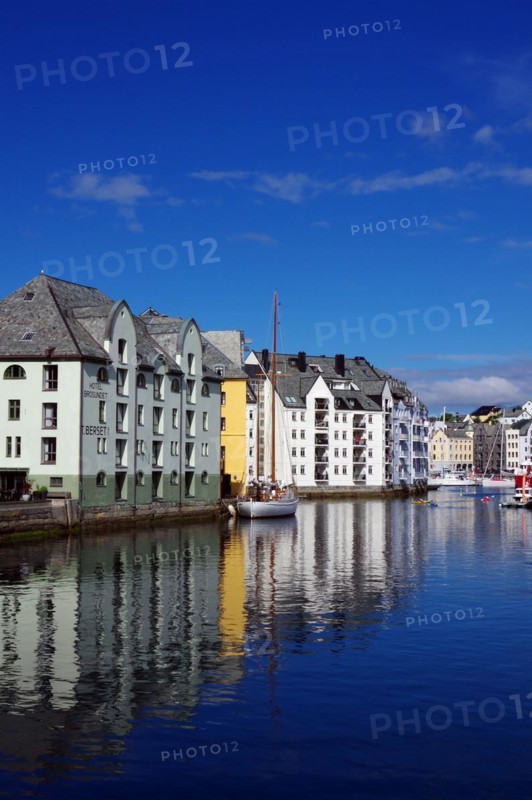 Houses reflected in the calm waters of a harbour, Art Nouveau, Kaiser Wilhelm II, Alesund, Norway, Europe
