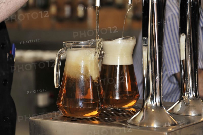 Solabrena, Two mugs of beer are freshly tapped at the bar with foam, Andalusia, Spain, Europe
