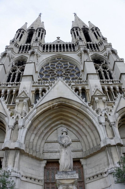 Church of Saint-Vincent-de-Paul, The facade of a Gothic church with detailed sculptures against a grey sky, Marseille, Departement Bouches-du-Rhone, Provence-Alpes-Cote d'Azur region, France, Europe