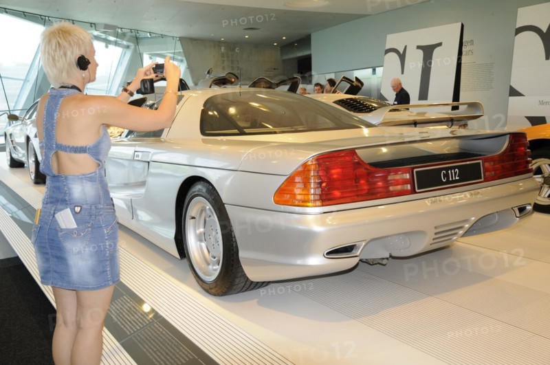 Museum, Mercedes-Benz Museum, Stuttgart, Woman takes a photo of the rear of a silver Mercedes-Benz C112 in a showroom, Mercedes-Benz Museum, Stuttgart, Baden-Wuerttemberg, Germany, Europe