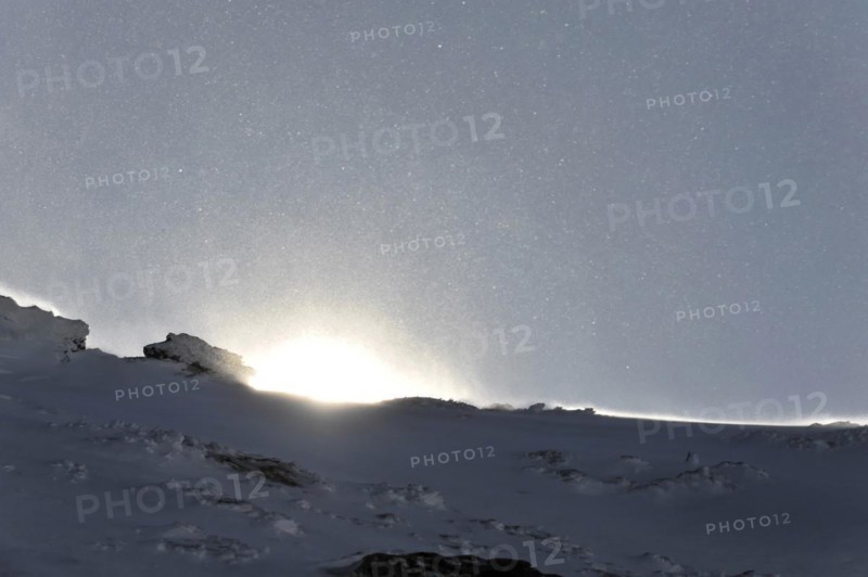 Mountains in Andalusia, mountain range with snow, near Pico del Veleta, 3392m, Gueejar-Sierra, Sierra Nevada National Park, sunrise behind a snow-covered mountain peak with sparkling ice crystals in the air, Costa del Sol, Andalusia, Spain, Europe