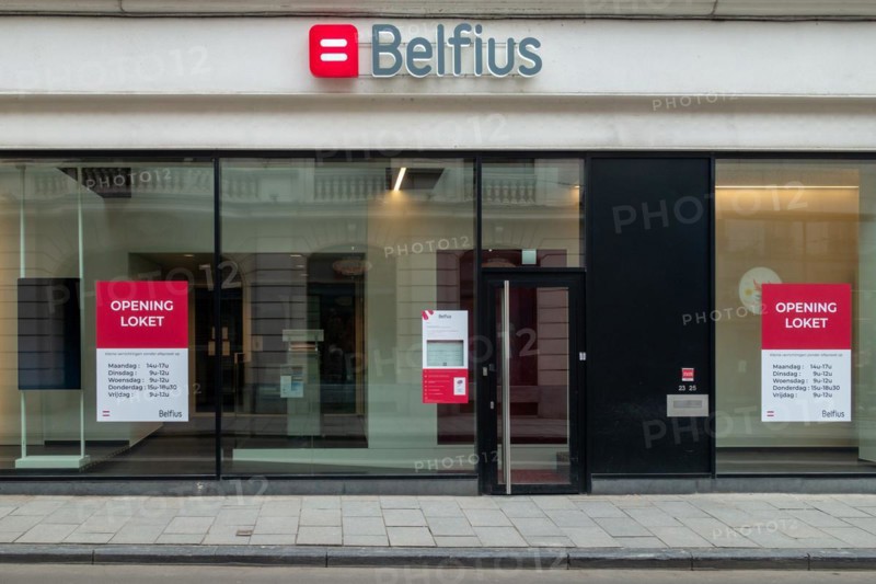 Office window showing opening hours of Belfius bank branch in the city Ghent, East Flanders, Belgium, Europe