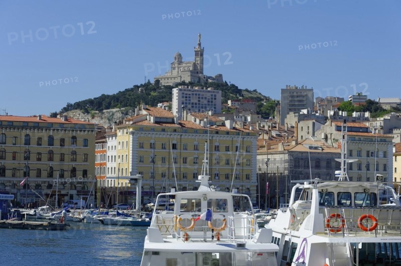 The old harbour, Vieux Port, behind the basilica Notre-Dame de la Garde, view of a harbour with boats and a fortress on a hill in the background, Marseille, Departement Bouches-du-Rhone, Region Provence-Alpes-Cote d'Azur, France, Europe