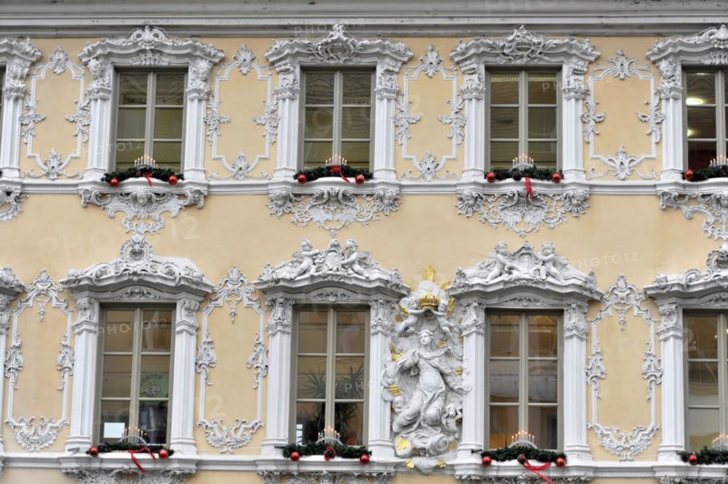 Facade view of the Falkenhaus with stucco facade in rococo style in the centre of Wuerzburg, rococo facade in white and gold with Christmas accents on the windows, Wuerzburg, Lower Franconia, Bavaria, Germany, Europe