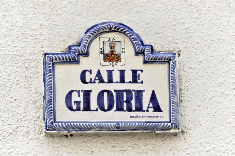 Solabrena, Ceramic street sign 'Calle Gloria' with blue and white lettering and ornaments, Andalusia, Spain, Europe