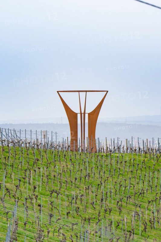 Large metal sculpture in the middle of a vineyard with a hilly landscape in the background, Jesus Grace Chruch, Weitblickweg, Easter hike, Hohenhaslach, Germany, Europe