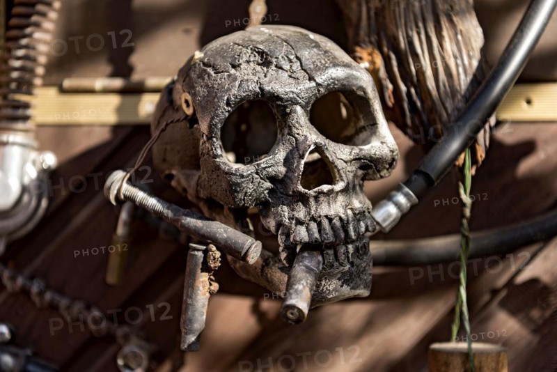 Old entrance door whimsically decorated, skull, engine parts, cartridge cases, tools, old town, Ortenberg, Vogelsberg, Wetterau, Hesse, Germany, Europe