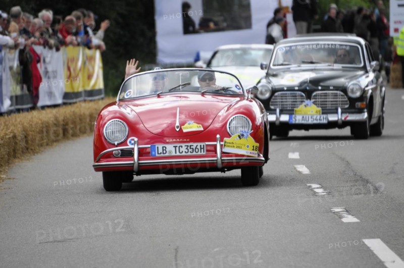 A red Porsche 356 at a classic car rally surrounded by spectators, SOLITUDE REVIVAL 2011, Stuttgart, Baden-Wuerttemberg, Germany, Europe