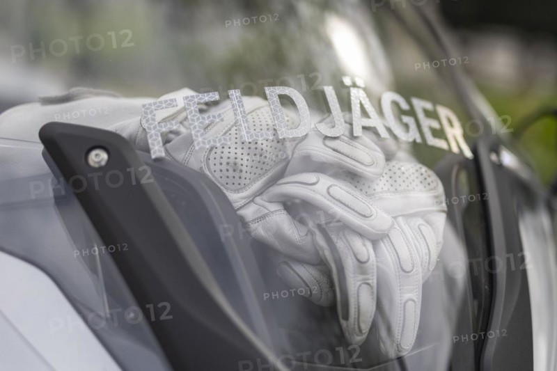 Gloves lie behind the windscreen of a military police motorbike in Berlin, 05/04/2024