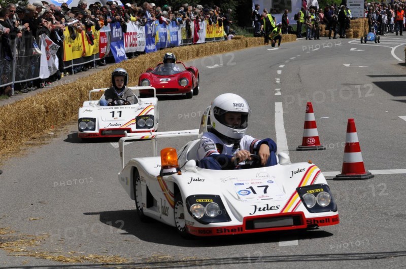 Racers concentrate on the race in white soapboxes in front of a crowd, SOLITUDE REVIVAL 2011, Stuttgart, Baden-Wuerttemberg, Germany, Europe