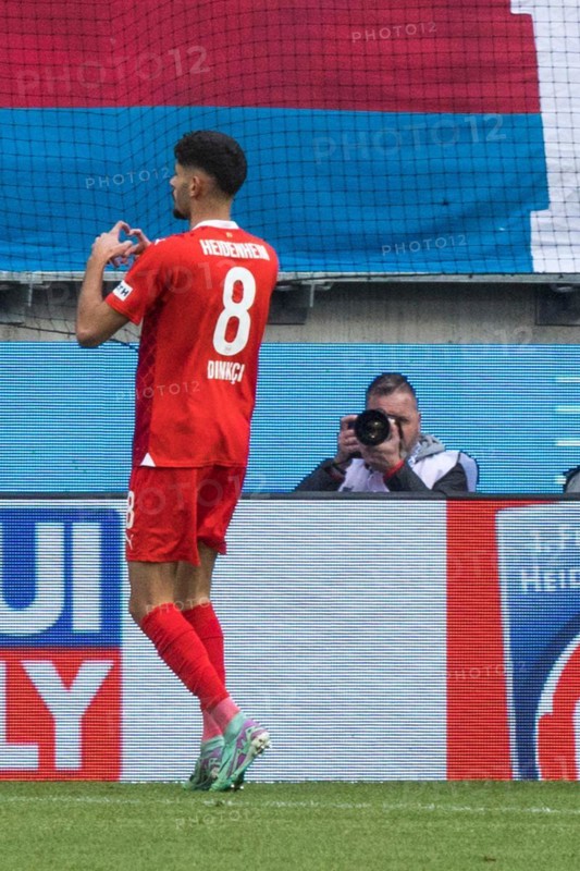 Football match, Eren DINKCI 1.FC Heidenheim has just scored the 1 to 1 equaliser and has given his heart to the Heidenheim fans, Voith-Arena football stadium, Heidenheim