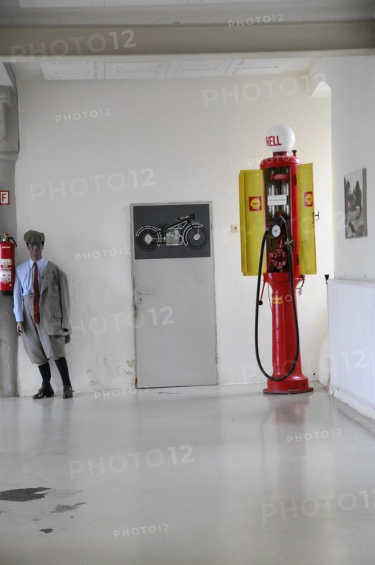 Deutsches Automuseum Langenburg, Old red Shell petrol pump next to a motorbike replica in a museum, Deutsches Automuseum Langenburg, Langenburg, Baden-Wuerttemberg, Germany, Europe