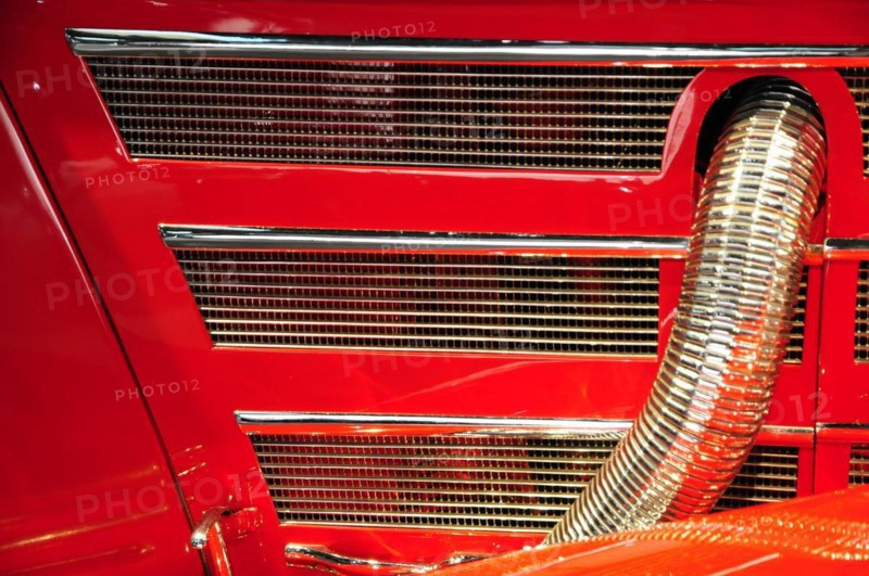 Close-up of the radiator grille of a red classic car with striking chrome details, Mercedes-Benz Museum, Stuttgart, Baden-Wuerttemberg, Germany, Europe