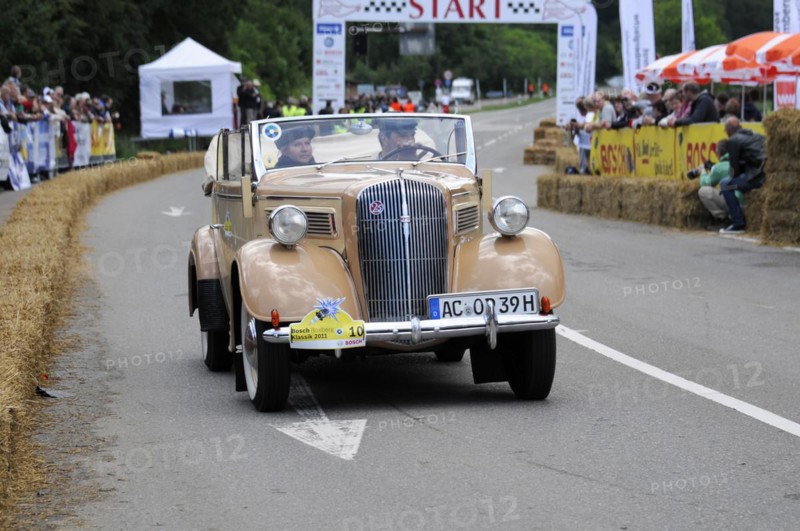 Old beige convertible driving on a road in front of an audience at a classic car race, SOLITUDE REVIVAL 2011, Stuttgart, Baden-Wuerttemberg, Germany, Europe