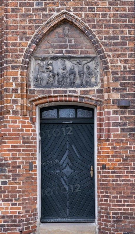 Relief with crucified Christ above a door of the parish church of St Laurentius, Havelberg, Saxony-Anhalt, Germany, Europe