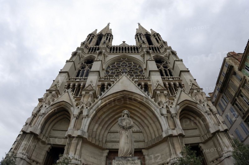 Church of Saint-Vincent-de-Paul, exterior view of a Gothic-style church with a statue in the foreground under a cloudy sky, Marseille, Departement Bouches-du-Rhone, Provence-Alpes-Cote d'Azur region, France, Europe