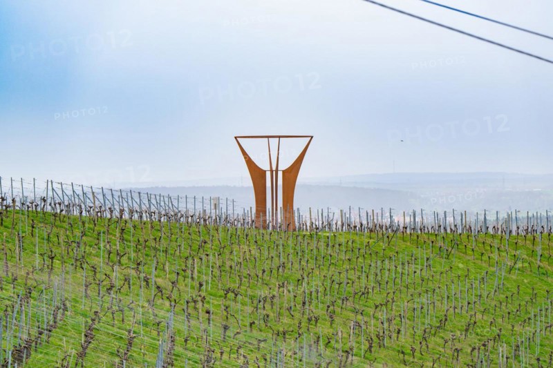 Expansive vineyard landscape with a striking art installation under a cloudy sky, Jesus Grace Chruch, Weitblickweg, Easter hike, Hohenhaslach, Germany, Europe