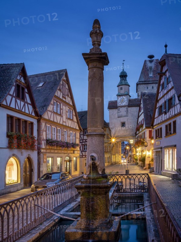 Roedergasse with Roederbrunnen, Markusturm and Roederbogen at dawn, Rothenburg ob der Tauber, Middle Franconia, Bavaria, Germany, Europe