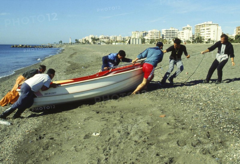 Fisherman pulling up boat on the beach in Torre del Mar, Malaga province, Costa del Sol, Andalusia, Mediterranean Sea, Spain, Southern Europe. Scanned thumbnail slide, Europe