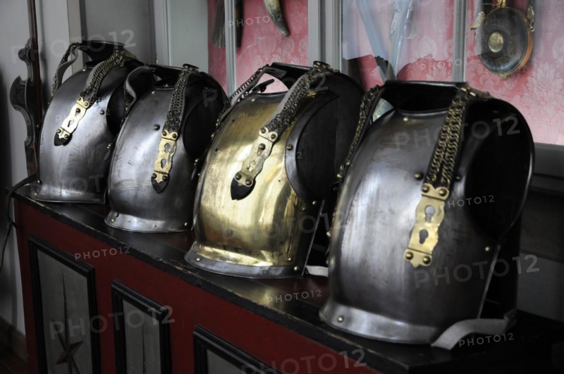 Langenburg Castle, row of shiny metal helmets with chains on a red surface, Langenburg Castle, Langenburg, Baden-Wuerttemberg, Germany, Europe