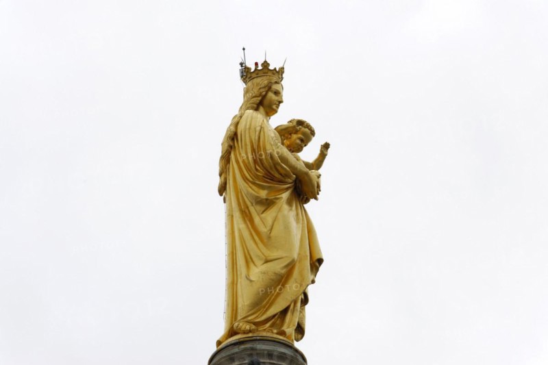 Madonna, Church of Notre-Dame de la Garde, Marseille, A golden statue of Mary with the child Jesus in front of a cloudy sky, Marseille, Departement Bouches-du-Rhone, Region Provence-Alpes-Cote d'Azur, France, Europe