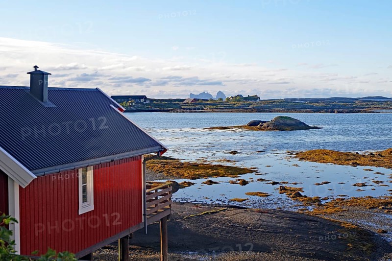 Red building with balcony by the water, Rorbuer, holiday, accommodation, Lovund, Lovunden, Helgeland coast, Norway, Europe