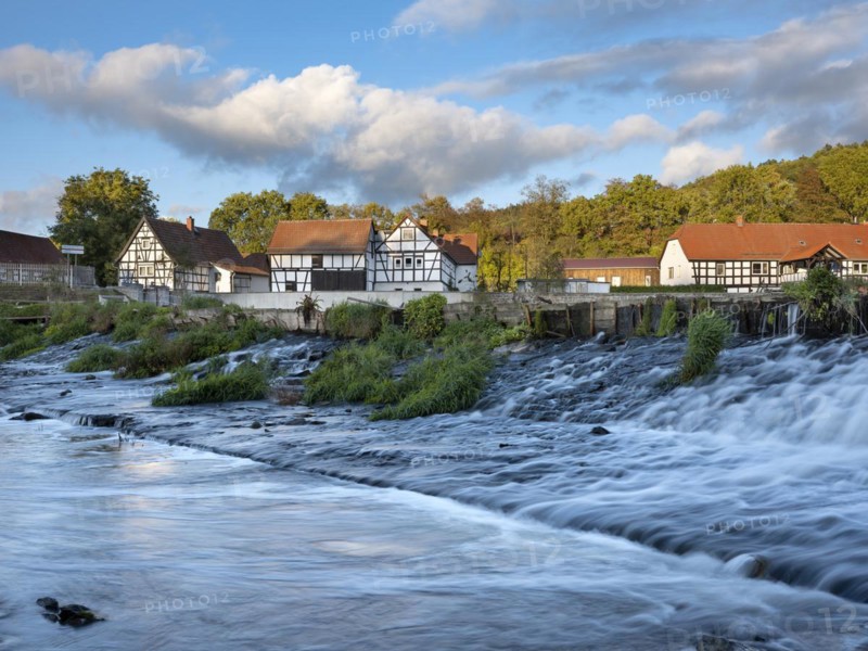 Half-timbered houses on the Weisse Elster river with weir, Wuenschendorf (Elster), Thuringia, Germany, Europe