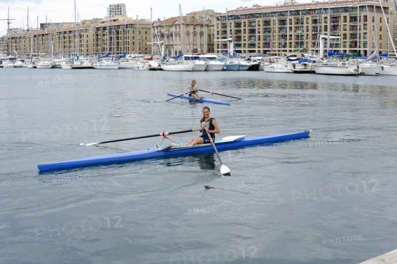 Marseille harbour, Two rowers in a rowing boat in a harbour area, Marseille, Departement Bouches-du-Rhone, Region Provence-Alpes-Cote d'Azur, France, Europe