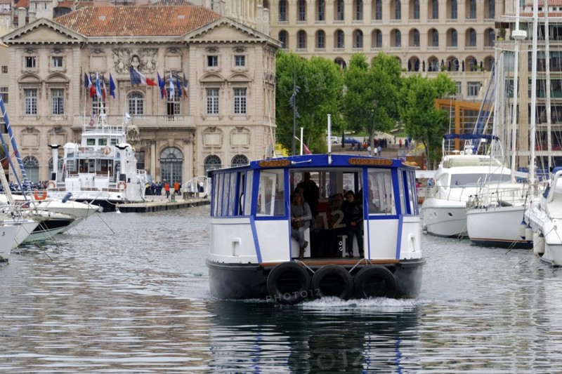 Marseille harbour, A small ferry with passengers crosses the harbour water, Marseille, Departement Bouches-du-Rhone, Region Provence-Alpes-Cote d'Azur, France, Europe