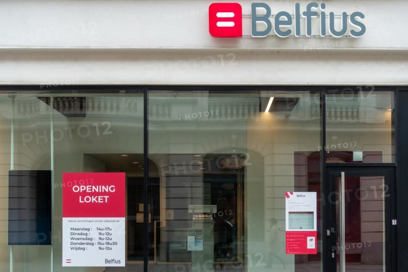 Office window showing opening hours of Belfius bank branch in the city Ghent, East Flanders, Belgium, Europe