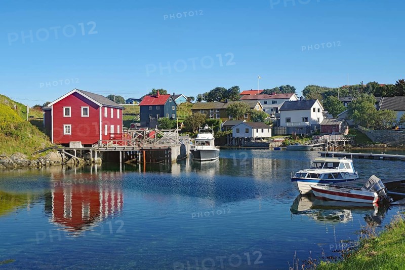 Small houses and boats in a sheltered bay, Lovunden, Helgeland coast, Traena, Norway, Europe