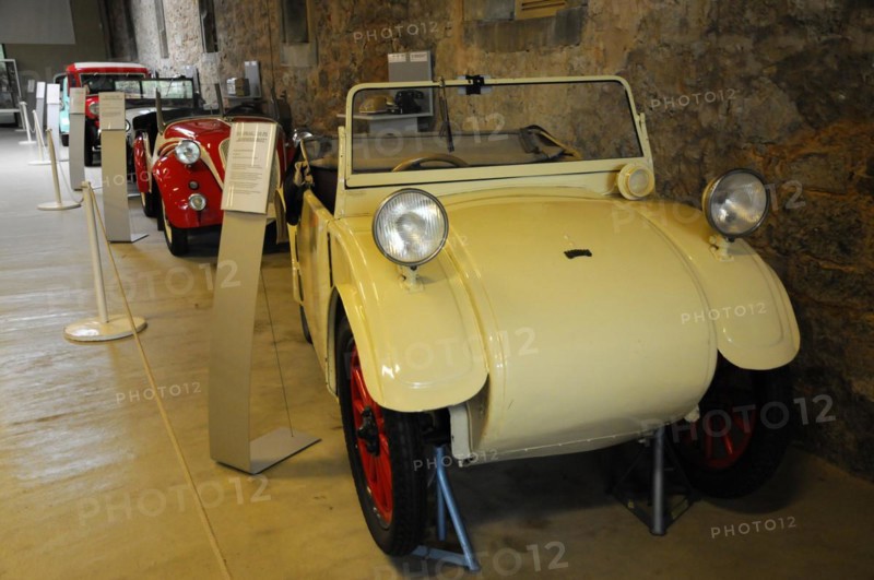 Deutsches Automuseum Langenburg, A small white vintage car in a museum, next to an information stand, Deutsches Automuseum Langenburg, Langenburg, Baden-Wuerttemberg, Germany, Europe