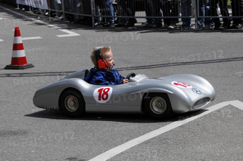Child driving a soapbox during a competition, watched by spectators at the side of the track, SOLITUDE REVIVAL 2011, Stuttgart, Baden-Wuerttemberg, Germany, Europe
