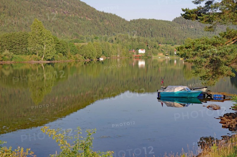 Trees and a small boat are reflected in a calm lake, old waterway, Telemark Canal, Telemark, Norway, Europe