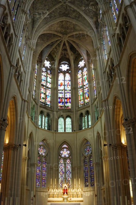 Church of Saint-Vincent-de-Paul, interior view of a church choir with Gothic stained glass windows and warm lighting conditions, Marseille, Departement Bouches-du-Rhone, Provence-Alpes-Cote d'Azur region, France, Europe