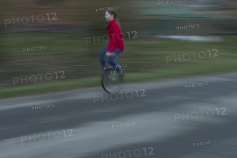 Girl, 10 years old, riding a unicycle, motion blur, Mecklenburg-Vorpommern, Germany, Europe